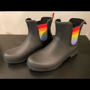 Chooka rain boots with rainbow accents.